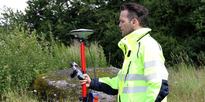 Man arbetar med navigeringsutrustning utomhus